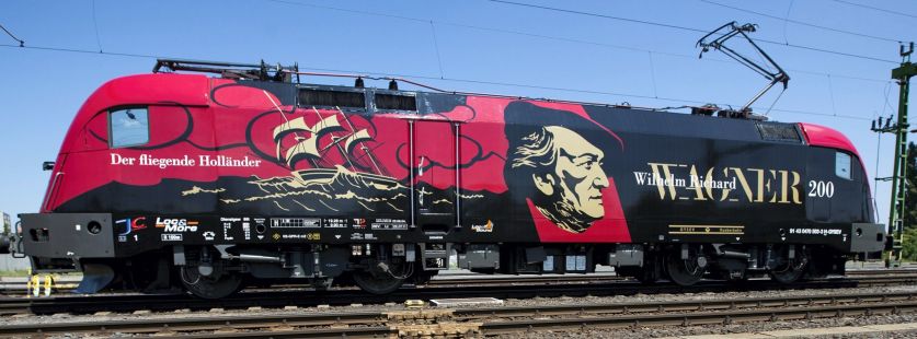A Győr-Sopron-Ebenfurti Vasút Zrt. (GYSEV) Richard Wagner német zeneszerző születésének 200. évfordulójának tiszteletére felmatricázott Taurus mozdonya az átadási ünnepségén a soproni vasútállomáson. Magyarország egyetlen zenélő mozdonya mostantól a zeneszerző világszerte ismert dallamát, a Walkürök lovaglását játssza a vasútállomásokon megálláskor. (MTI Fotó: Nyikos Péter) A Győr-Sopron-Ebenfurti Vasút Zrt. (GYSEV) Richard Wagner német zeneszerző születésének 200. évfordulójának tiszteletére felmatricázott Taurus mozdonya az átadási ünnepségén a soproni vasútállomáson. Magyarország egyetlen zenélő mozdonya mostantól a zeneszerző világszerte ismert dallamát, a Walkürök lovaglását játssza a vasútállomásokon megálláskor. (MTI Fotó: Nyikos Péter)