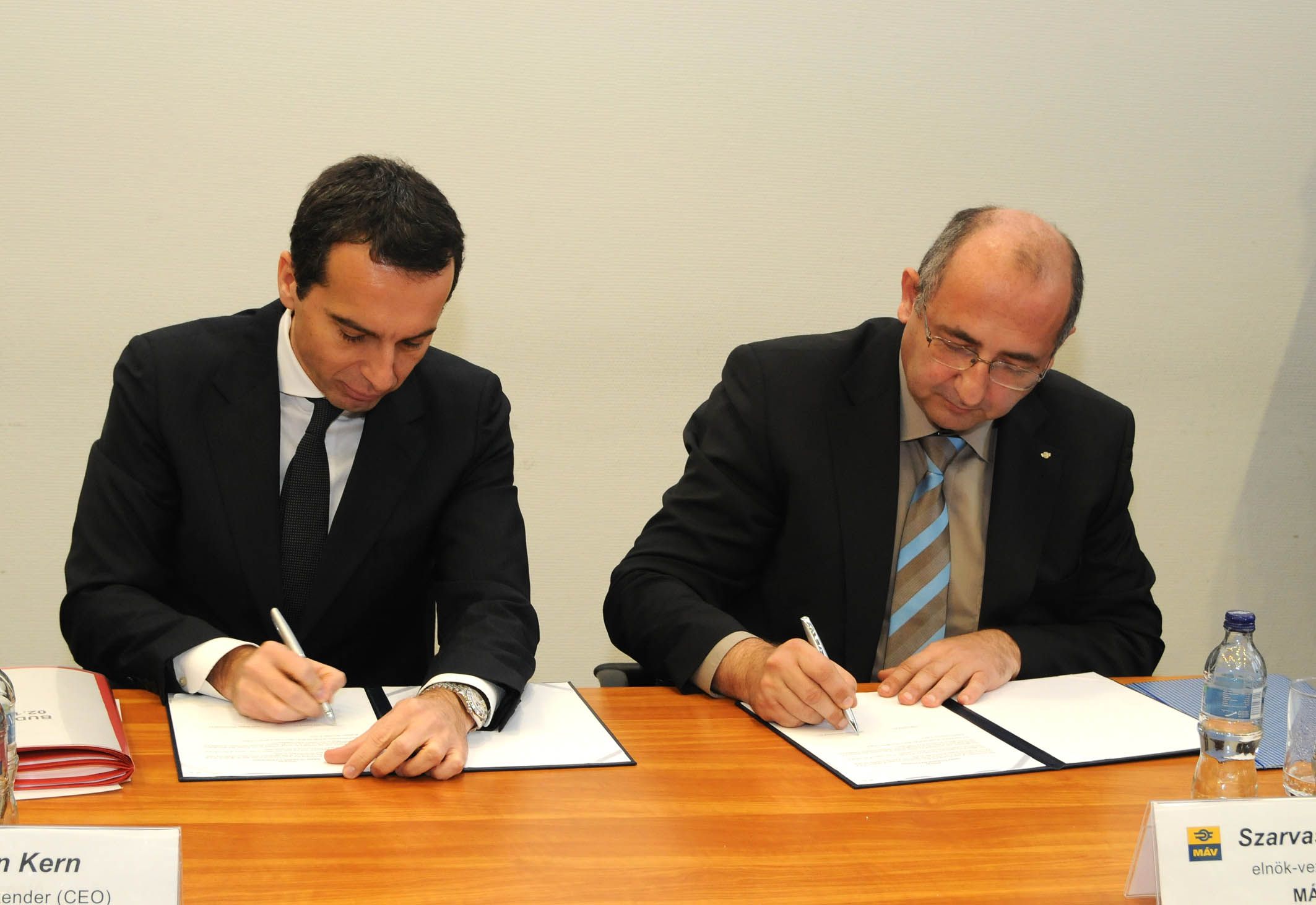 Christian Kern, az ÖBB-Holding AG vezérigazgatója és Szarvas Ferenc, a MÁV Zrt. elnök-vezérigazgatója aláírja a dokumentumot. (Foto: MÁV Zrt.)